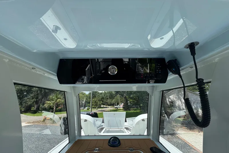 Slide: The Image of Interior view of 2024 Freeman 28 boat cockpit with control panel and windows. - 23
