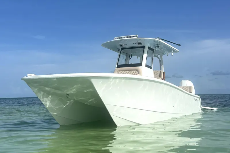 Slide: The Image of 2024 Freeman 28 boat on calm sea under clear blue sky. - 3