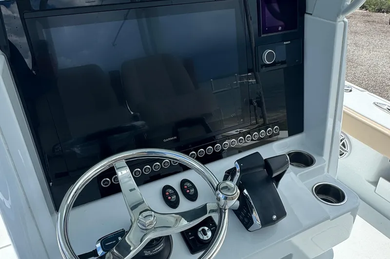 Slide: The Image of 2024 Freeman 28 boat dashboard with steering wheel and control panel. - 30
