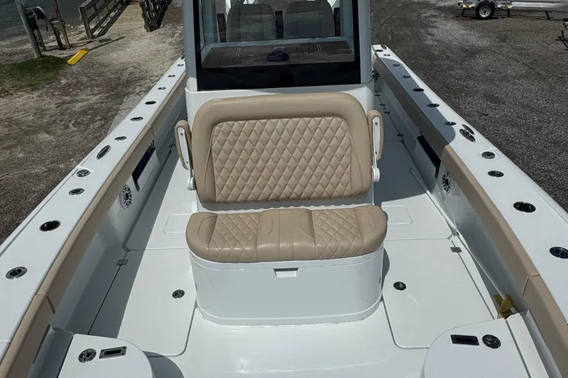 Slide: The Image of 2024 Freeman 28 boat interior with beige quilted seating and spacious deck layout. - 32