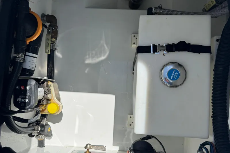 Slide: The Image of Interior view of 2024 Freeman 28 boat showing water tank and plumbing components. - 38