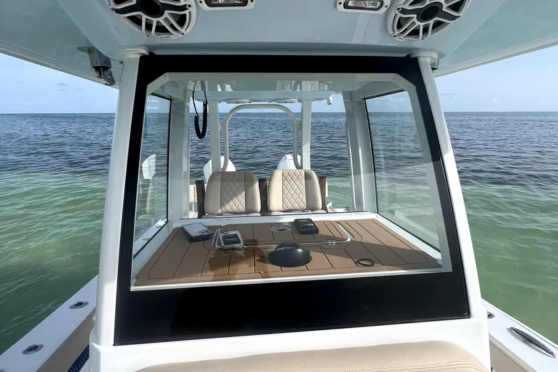 Slide: The Image of 2024 Freeman 28 boat interior with ocean view, featuring modern dashboard and seating. - 5