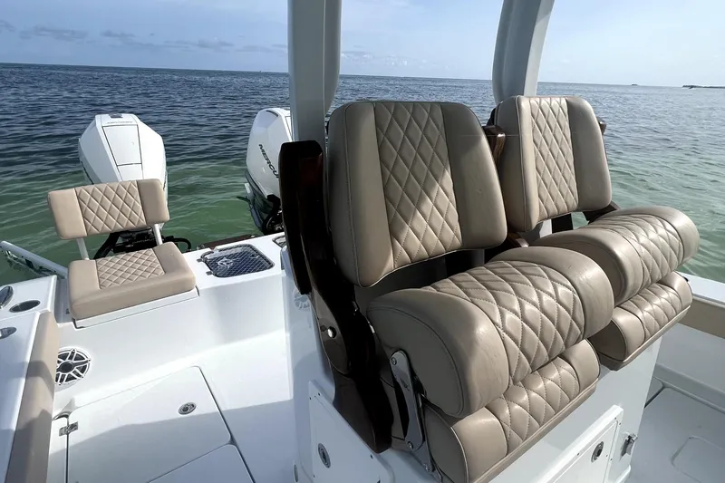 Slide: The Image of 2024 Freeman 28 boat with luxurious quilted seating and dual outboard motors on open water. - 9