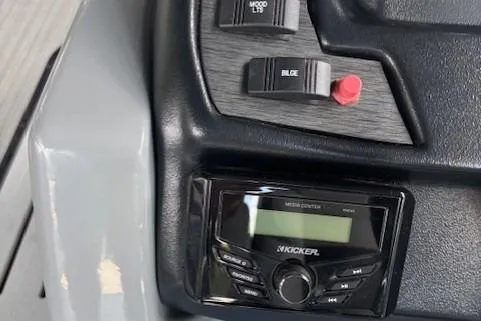 Slide: The Image of 2023 Veranda Relax VR22RC dashboard with Kicker audio system and control switches. - 11