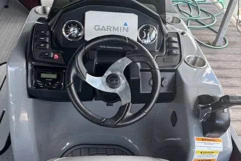 Slide: The Image of 2023 Veranda Relax VR22RC boat dashboard with Garmin navigation system and steering wheel. - 12