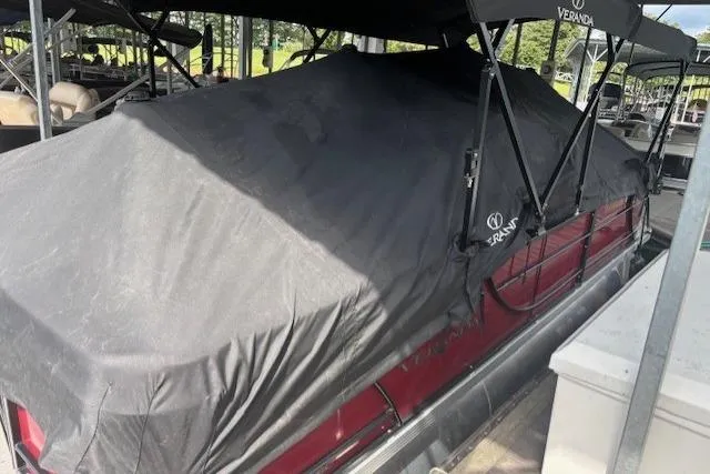 Slide: The Image of 2023 Veranda Relax VR22RC pontoon boat covered with a protective tarp at a dock. - 13