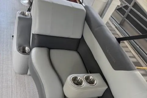 Slide: The Image of 2023 Veranda Relax VR22RC boat seating with cup holders, featuring gray upholstery. - 16