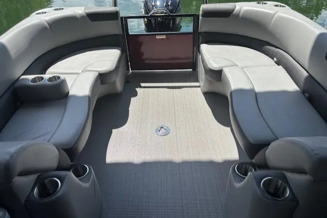 Slide: The Image of 2023 Veranda Relax VR22RC pontoon boat interior with gray seating and cup holders. - 22