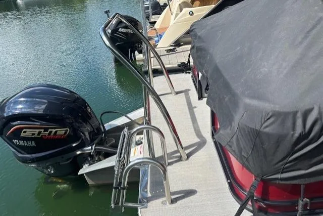 Slide: The Image of 2023 Veranda Relax VR22RC pontoon boat with Yamaha engine docked, covered, and ready for use. - 9