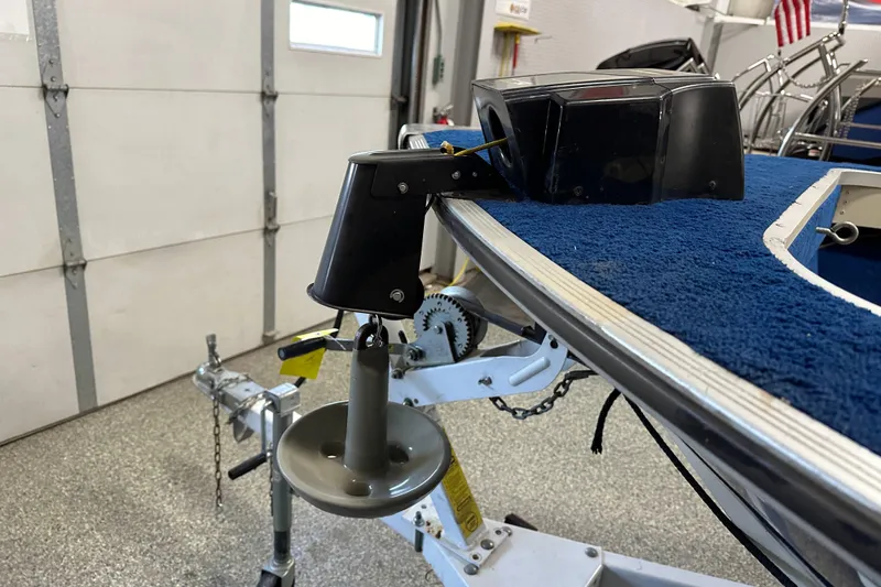 Slide: The Image of 1997 Sylvan 16 Super Select boat on trailer in garage, featuring blue carpeted deck. - 10