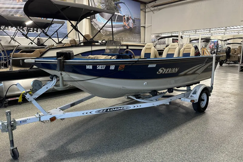 Slide: The Image of 1997 Sylvan 16 Super Select boat on trailer in showroom. - 2