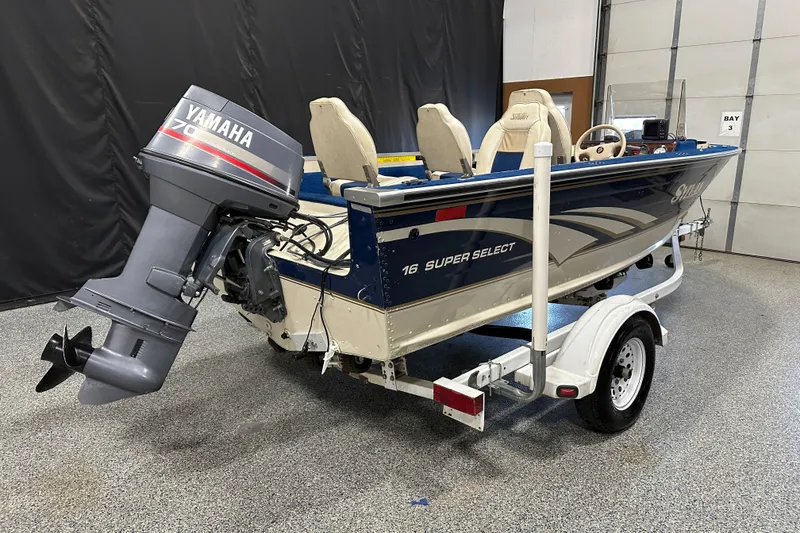 Slide: The Image of 1997 Sylvan 16 Super Select boat with Yamaha motor on trailer in garage. - 4