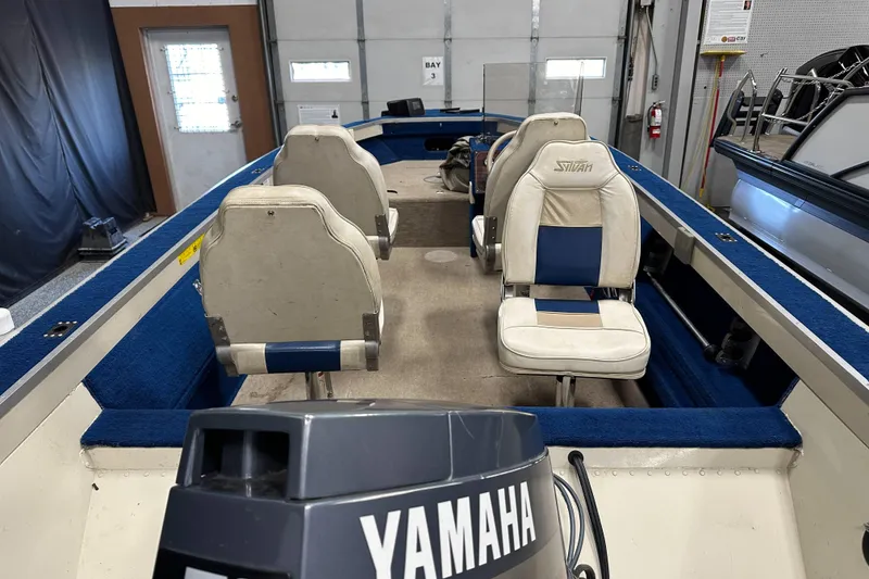 Slide: The Image of 1997 Sylvan 16 Super Select boat interior with Yamaha motor, featuring blue and white seating. - 5