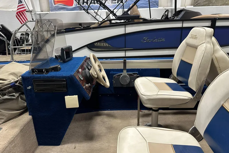 Slide: The Image of Interior of a 1997 Sylvan 16 Super Select boat with blue and white seating. - 7