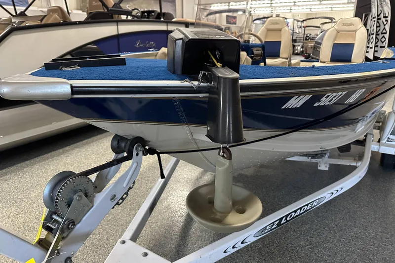 Slide: The Image of 1997 Sylvan 16 Super Select boat on EZ Loader trailer in showroom. - 8