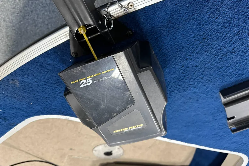 Slide: The Image of Electric anchor winch on 1997 Sylvan 16 Super Select boat, blue carpet background. - 9