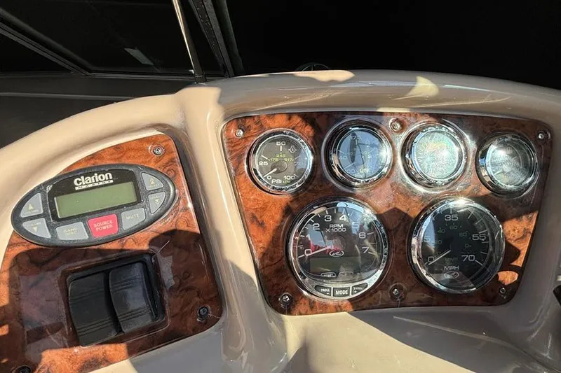 Slide: The Image of Dashboard of 2004 Sea Ray 260 Sundancer boat with gauges and controls. - 11