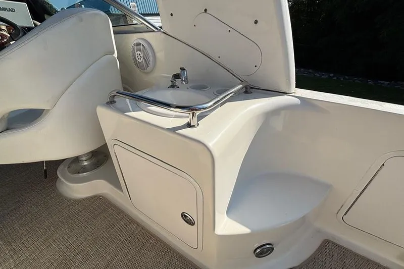 Slide: The Image of 2004 Sea Ray 260 Sundancer boat interior with sink and storage compartment. - 7