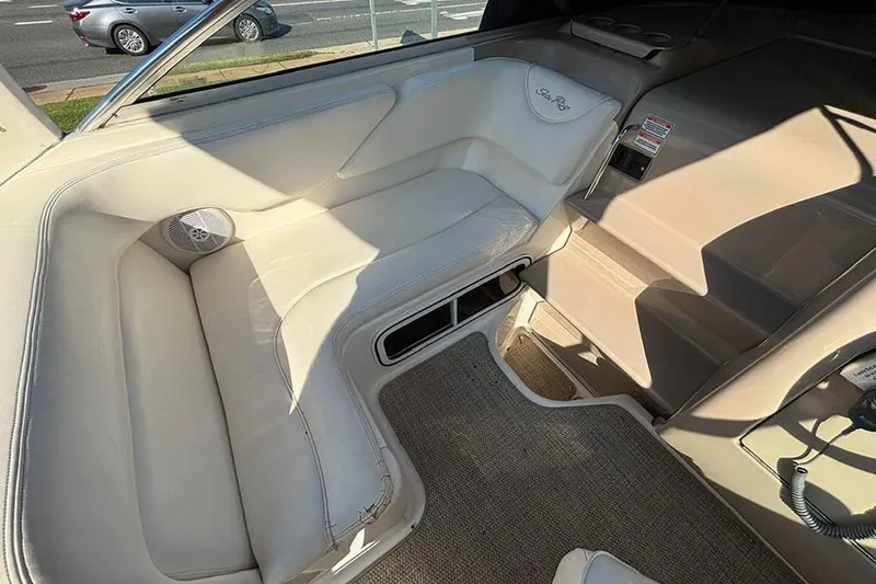 Slide: The Image of Interior of 2004 Sea Ray 260 Sundancer boat with beige seating and carpet. - 9