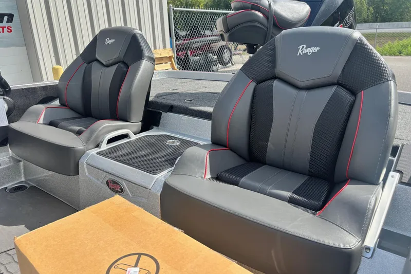 Slide: The Image of 2025 Ranger Z520R boat seats with black and red accents, parked outdoors. - 12