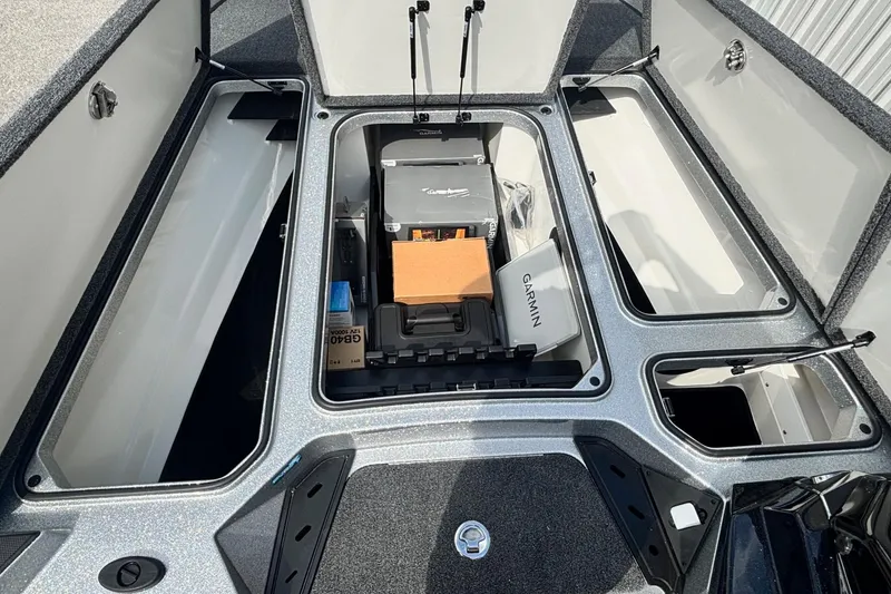 Slide: The Image of 2025 Ranger Z520R boat storage compartments with Garmin equipment and organized gear. - 5