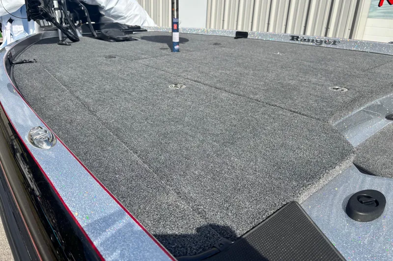 Slide: The Image of 2025 Ranger Z520R boat deck with gray carpet and sleek design. - 6