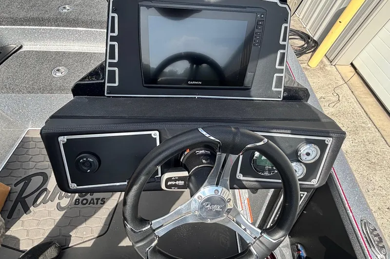Slide: The Image of 2025 Ranger Z520R boat dashboard with steering wheel and Garmin display. - 9