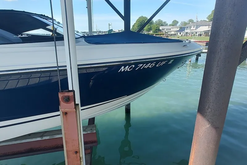 Slide: The Image of 2017 Sea Ray SLX 230 boat docked, displaying registration number MC 7146 UF. - 1