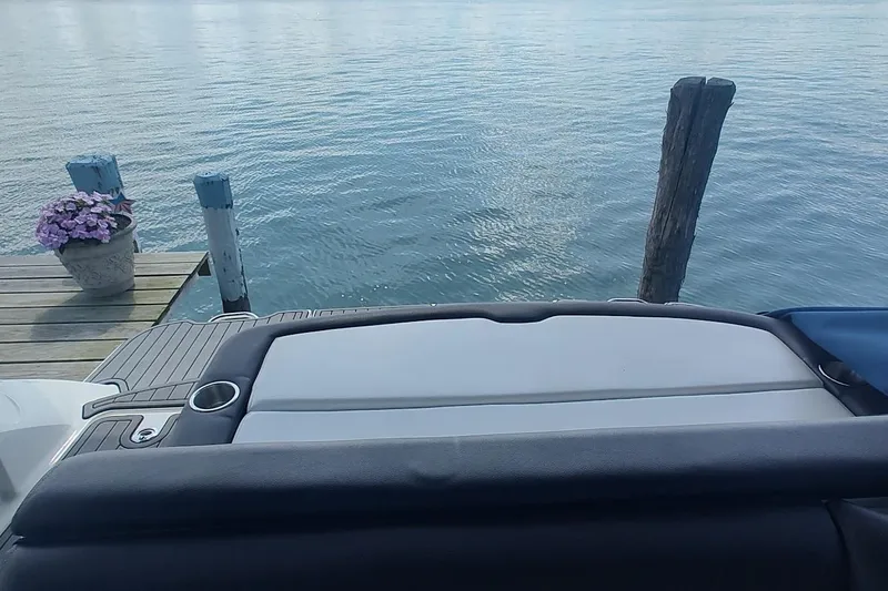 Slide: The Image of 2017 Sea Ray SLX 230 boat at dock with water view and flowers. - 11