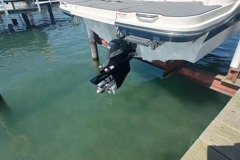 Slide: The Image of 2017 Sea Ray SLX 230 boat stern with outboard motor in clear water. - 5