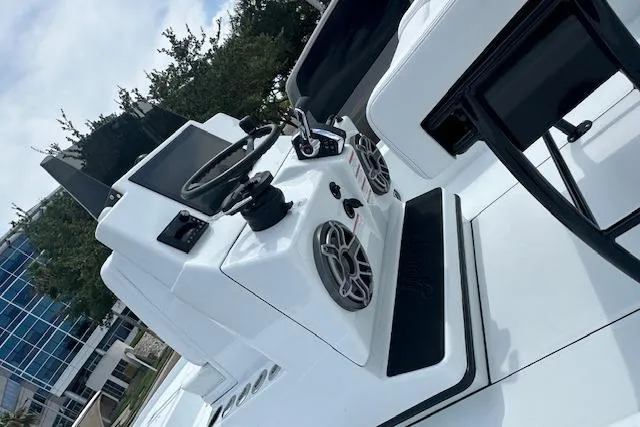 Slide: The Image of 2026 Yellowfin 24 CE boat with V8 engine on trailer, parked near waterfront. - 10