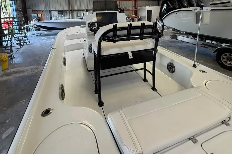 Slide: The Image of 2026 Yellowfin 24 CE boat in a warehouse, featuring a powerful outboard motor. - 3