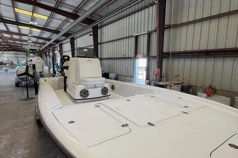 Slide: The Image of 2026 Yellowfin 24 CE boat interior with Mercury engine in a storage facility. - 6