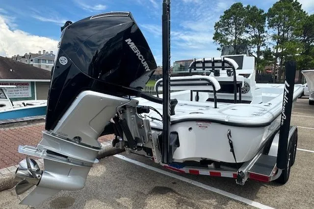 Slide: The Image of 2026 Yellowfin 24 CE boat interior with white seating in a warehouse setting. - 7