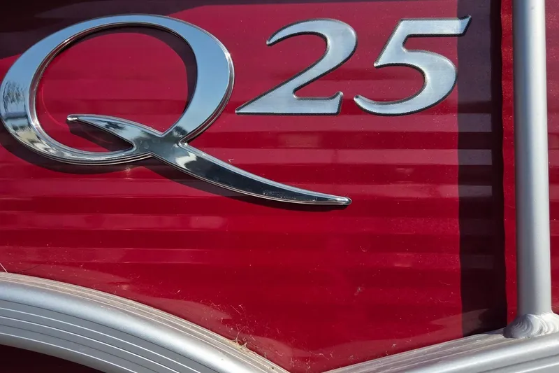 Slide: The Image of Close-up of 2019 Bennington Q 25 QCW logo on red background. - 2