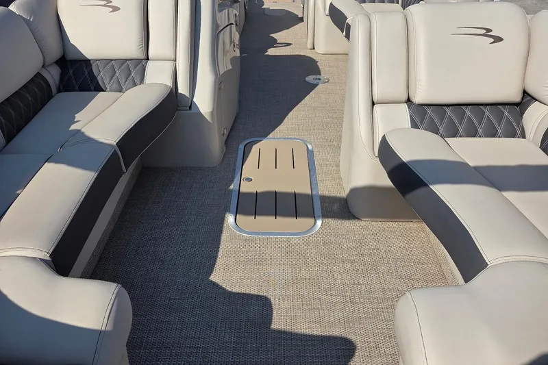 Slide: The Image of 2019 Bennington Q 25 QCW boat interior with beige seating and carpeted floor. - 4