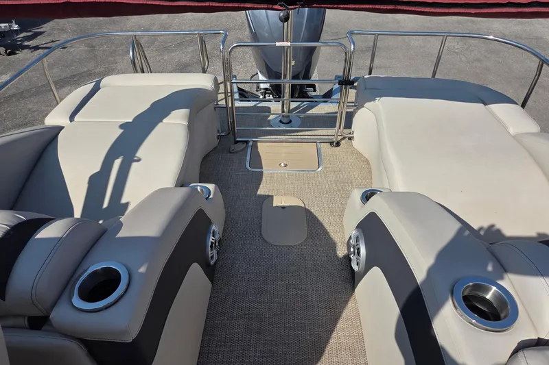 Slide: The Image of 2019 Bennington Q 25 QCW boat interior with beige seating and cup holders. - 6
