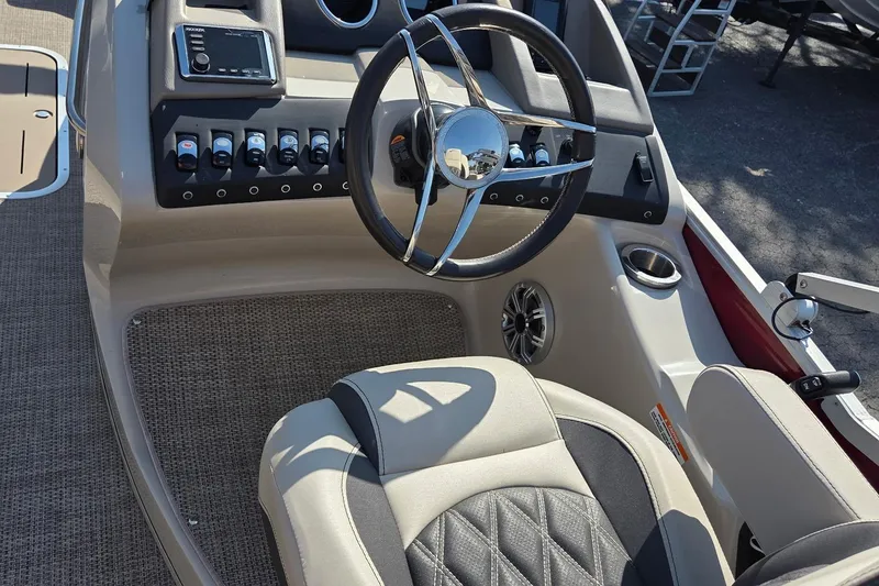 Slide: The Image of 2019 Bennington Q 25 QCW boat cockpit with steering wheel and control panel. - 7