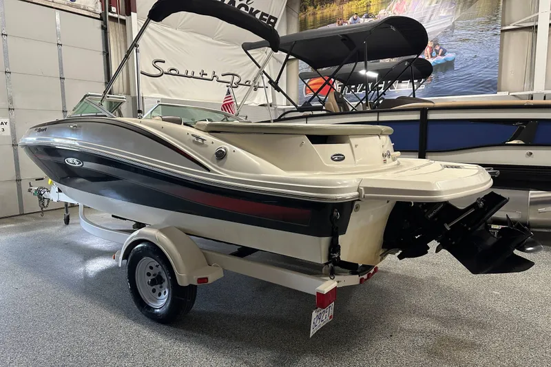 The Image of 2007 Sea Ray 185 Bow Rider boat on trailer in showroom setting. - 0