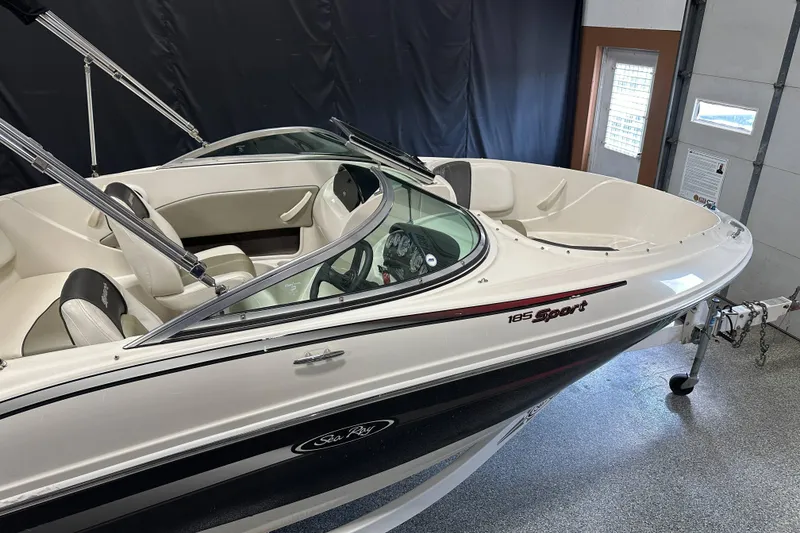 Slide: The Image of 2007 Sea Ray 185 Bow Rider boat interior with steering wheel and dashboard controls. - 10