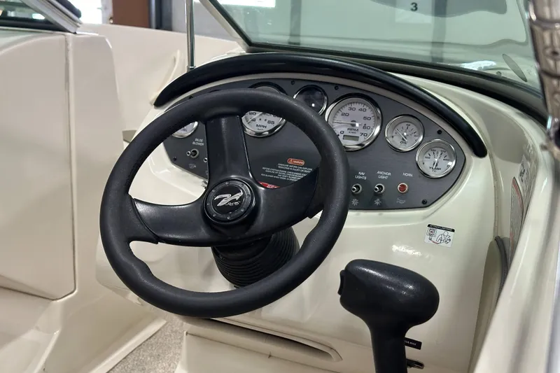 Slide: The Image of 2007 Sea Ray 185 Bow Rider interior with cushioned seating and cup holders. - 14