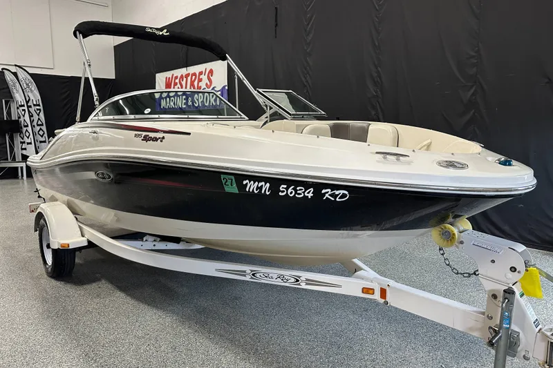 Slide: The Image of 2007 Sea Ray 185 Bow Rider boat on trailer in indoor showroom. - 2