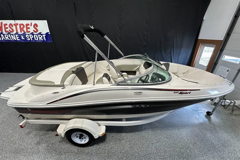 Slide: The Image of 2007 Sea Ray 185 Bow Rider boat on trailer, indoor display setting. - 9