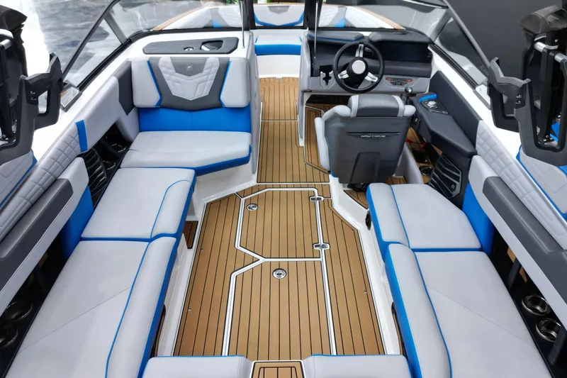 Slide: The Image of 2022 Nautique Super Air Nautique G23 interior with blue and gray seating, sleek design. - 12