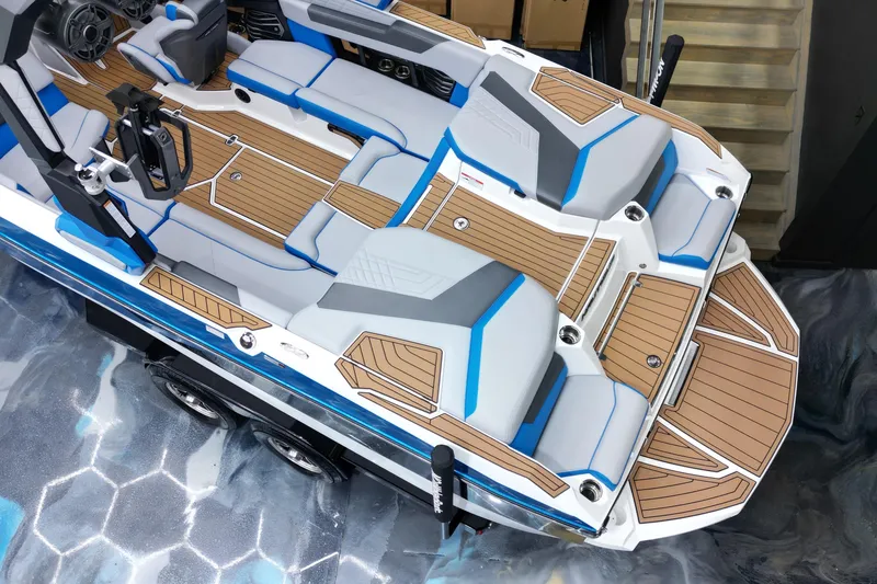 Slide: The Image of 2022 Nautique Super Air Nautique G23 boat interior with sleek seating and wood accents. - 14