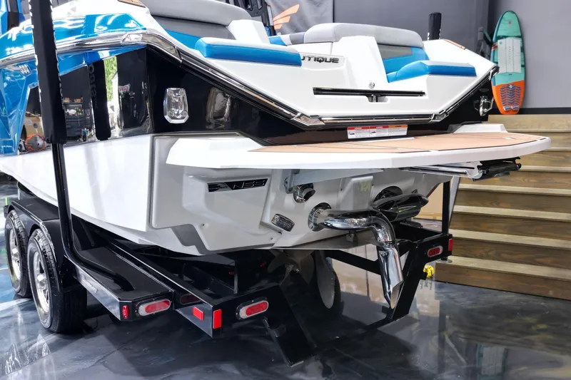 Slide: The Image of 2022 Nautique Super Air Nautique G23 boat on trailer, rear view in showroom. - 15