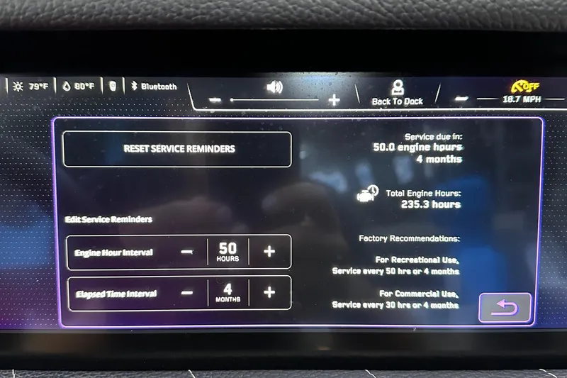 Slide: The Image of Touchscreen display of a 2022 Nautique Super Air Nautique G23 showing service reminders and engine hours. - 21