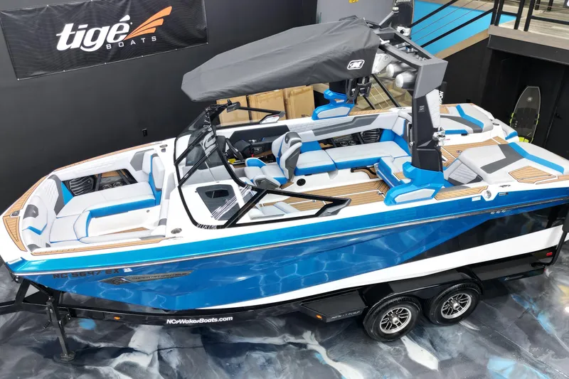 Slide: The Image of 2022 Nautique Super Air Nautique G23 boat with blue and white design on display. - 4