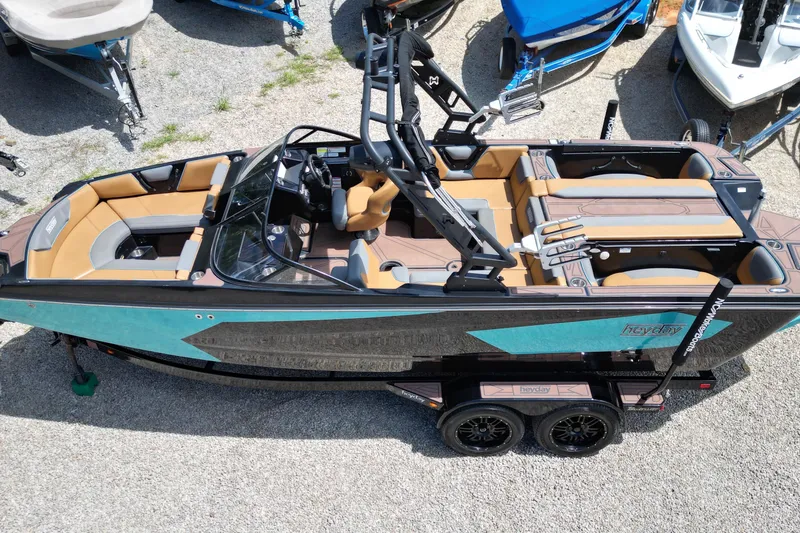 Slide: The Image of 2022 Heyday WTSurf boat with tan and teal interior, parked on gravel. - 13
