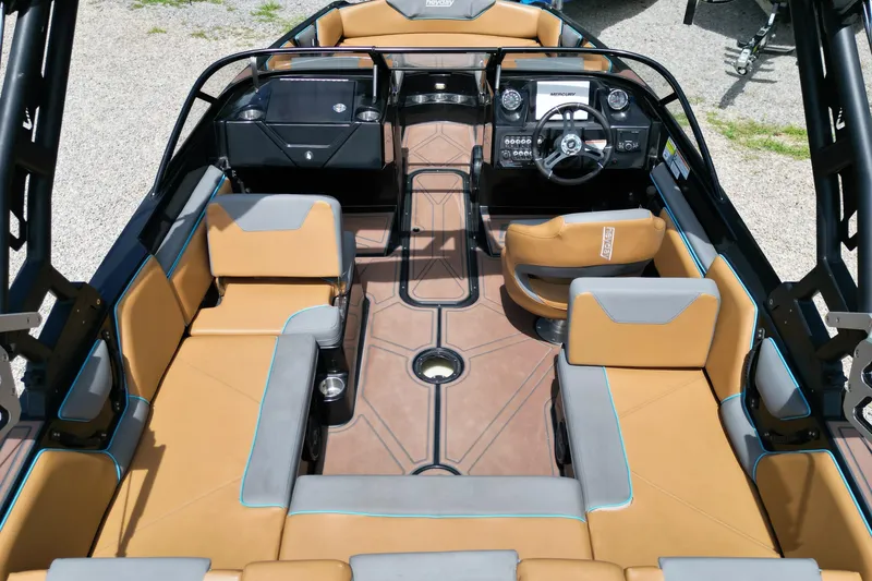 Slide: The Image of 2022 Heyday WTSurf boat interior with tan and gray seating, modern dashboard, and steering wheel. - 6